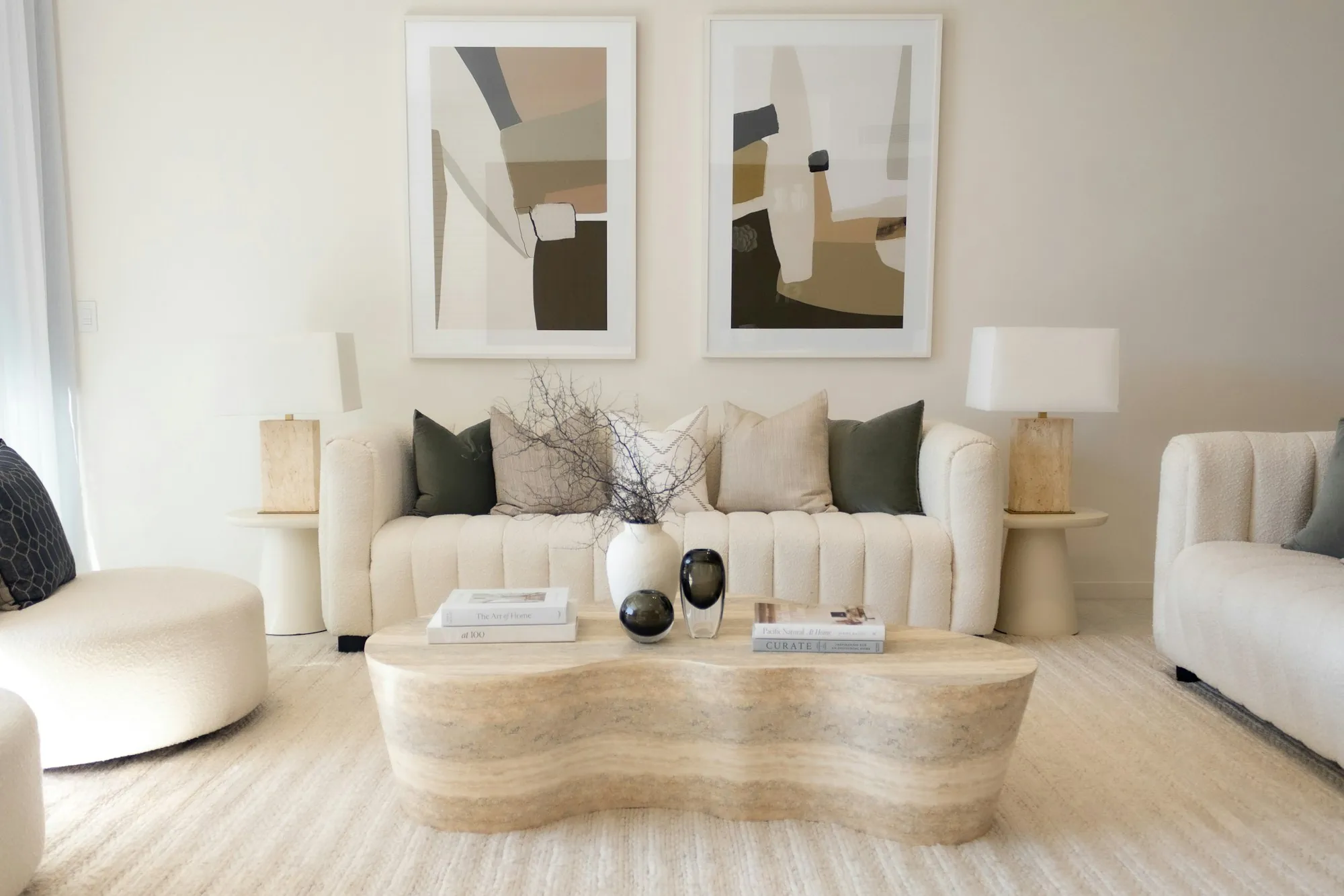 Neutral living room with a sculpted coffee table and cream sofa